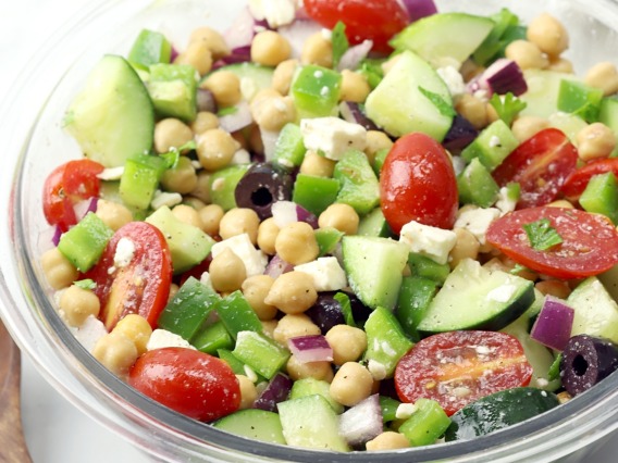 Chickpeas mixed with diced cucumbers, tomatoes, olives, and feta cheese