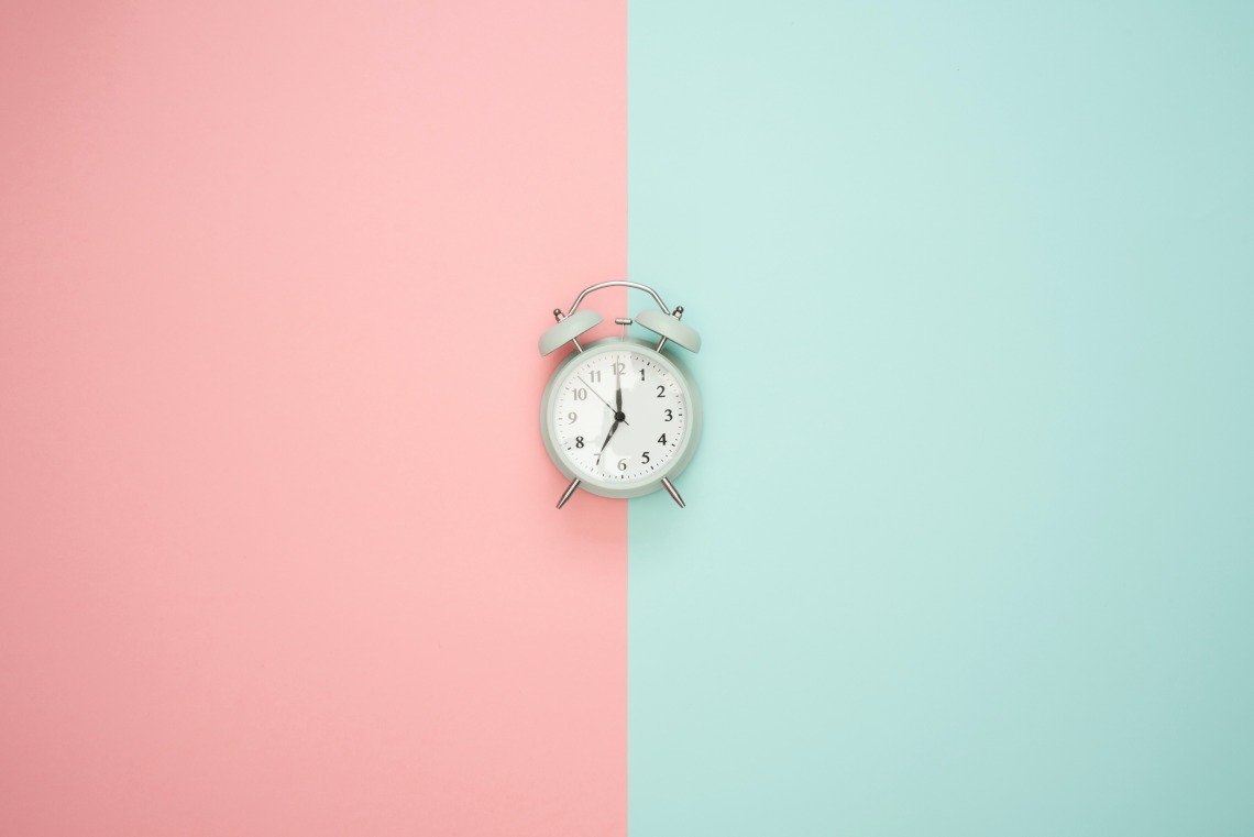 PInk and blue background picture of clock